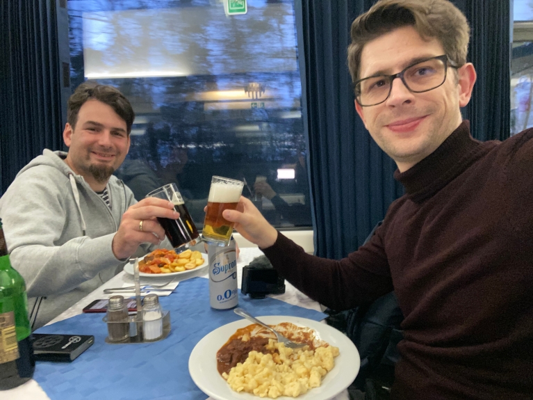 Lennart and Felix enjoy dinner on a dining car